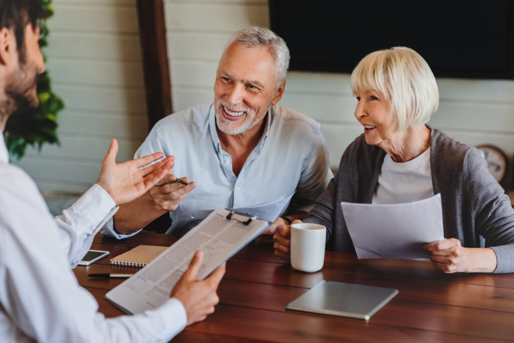 Two older people talking to an advisor about ways to give to charity