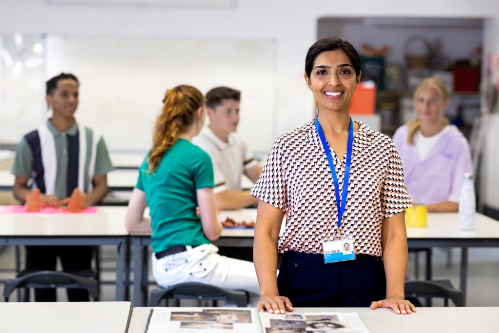 Teacher in front of students collaborating. Image for Student Design Contests​ page